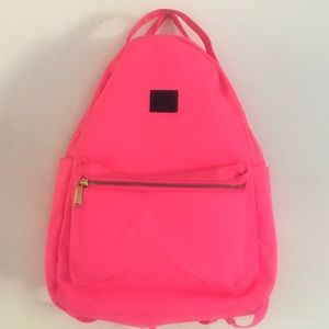 Neon pink mid-volume Herschel Nova backpack.